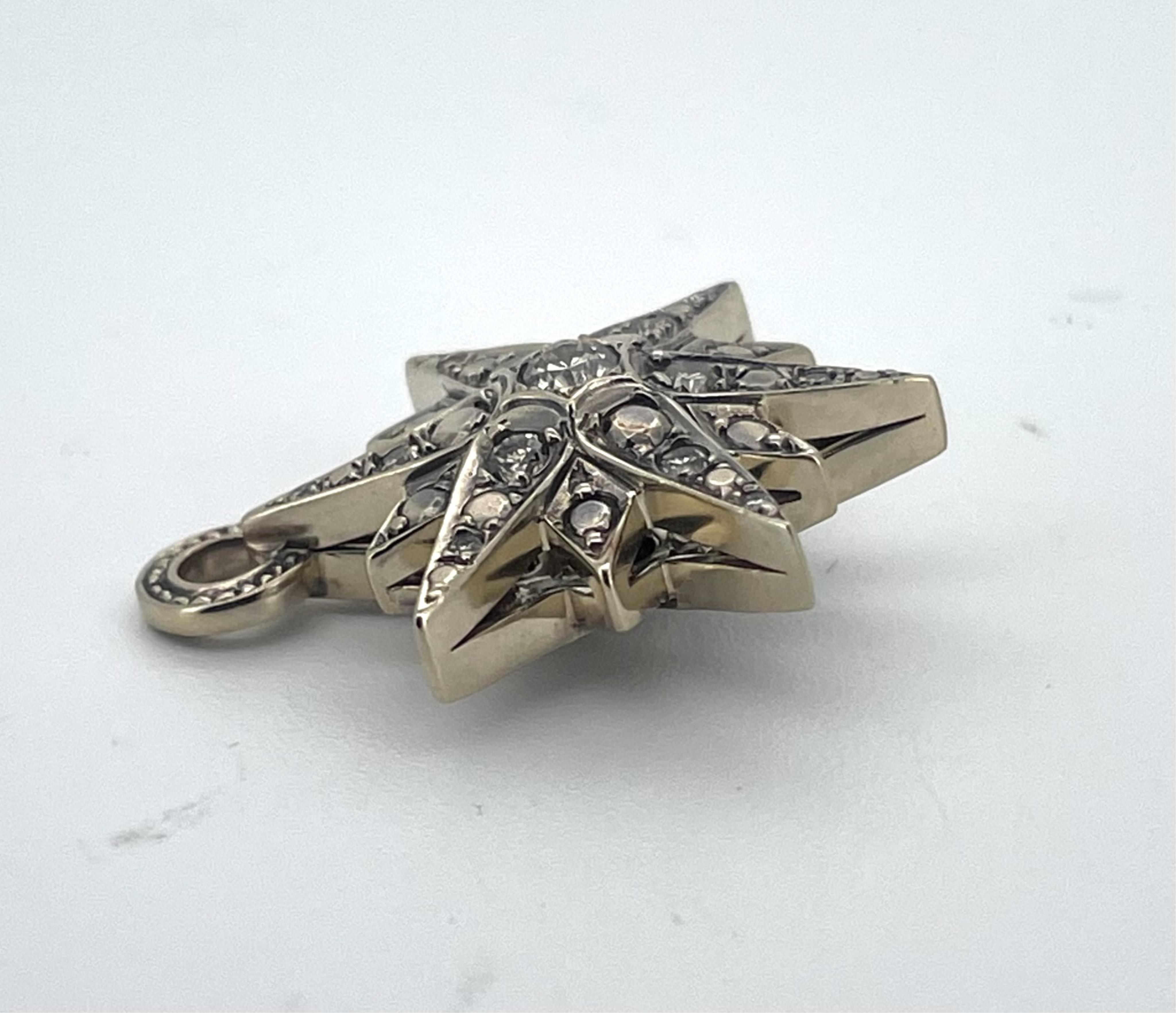 A diamond pendant, designed as star, set to both sides with brilliant-cut diamonds totalling approximately 0.90 carats, length 2.6cm, gross weight approximately 6.5 grams